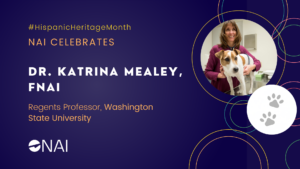 A graphic with the text "N.A.I. celebrates Dr. Katrina Mealey, F.N.A.I. Regents Professor, Washington State University." It includes the hashtag for Hispanic Heritage month, the NAI logo, and an image of Dr. Mealey smiling with a dog.